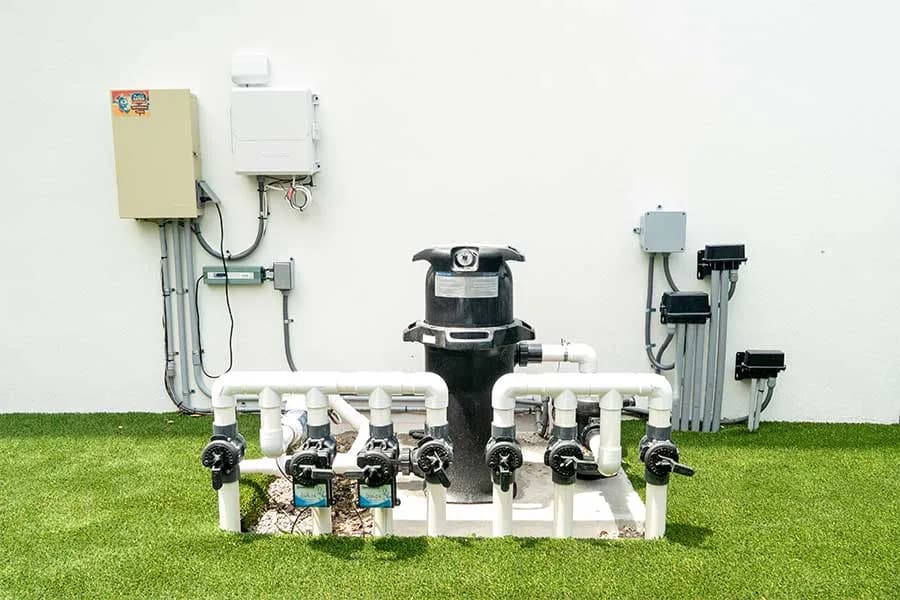 Pool equipment pad built by Perfect Catch — filter, valve manifold, timer and sub-panel wired and plumbed on one visit